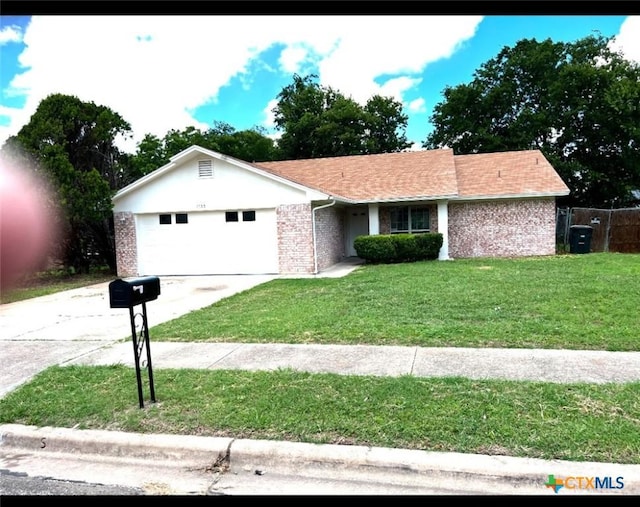 ranch-style house featuring a garage and a front lawn