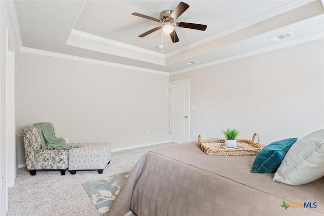 carpeted bedroom with a raised ceiling, ceiling fan, and crown molding