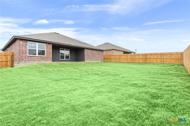 rear view of house with a yard