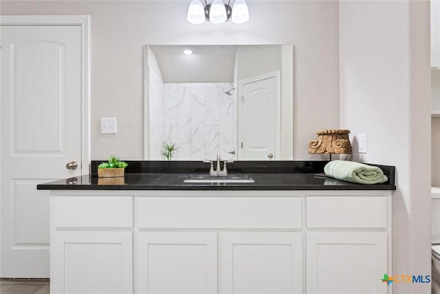 bathroom featuring a shower, vanity, and toilet