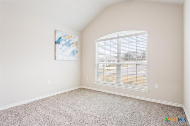 unfurnished room featuring carpet and lofted ceiling