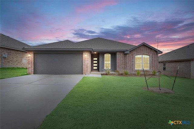 view of front of property with a lawn and a garage