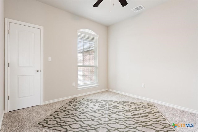 carpeted empty room with ceiling fan and a healthy amount of sunlight