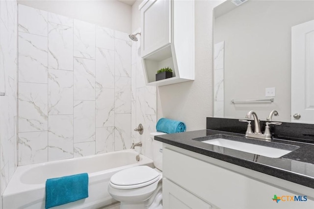 full bathroom featuring vanity, tiled shower / bath combo, and toilet