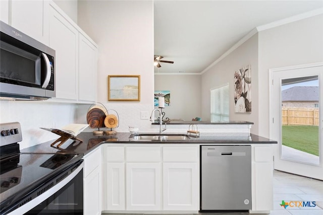 kitchen with white cabinetry, sink, kitchen peninsula, crown molding, and appliances with stainless steel finishes