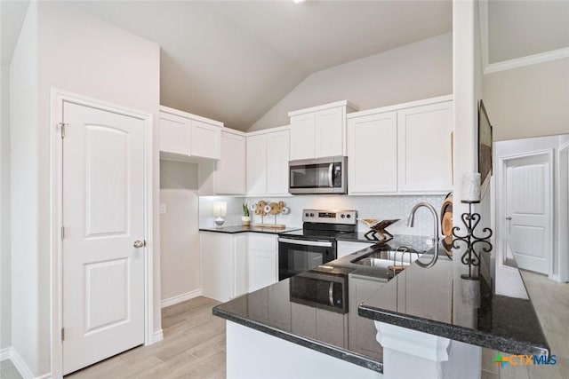 kitchen featuring white cabinets, appliances with stainless steel finishes, kitchen peninsula, and sink