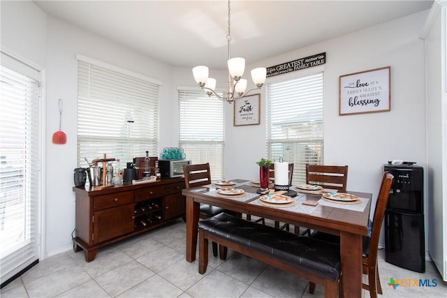 dining space featuring a notable chandelier and light tile patterned floors