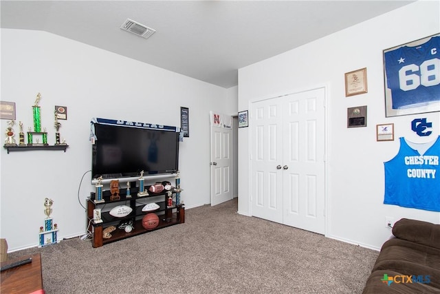 living room with carpet floors and vaulted ceiling