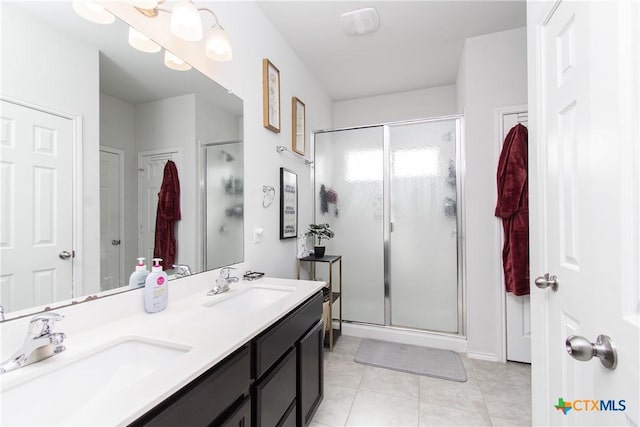 bathroom with vanity, tile patterned flooring, and a shower with shower door