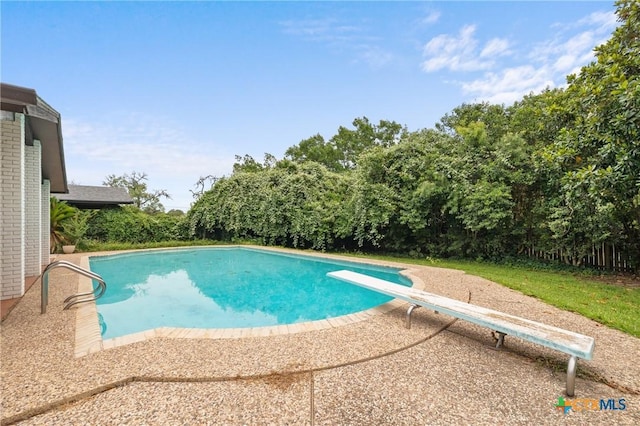 1223 N Sarah Dewitt Dr, Gonzales, TX 78629 - swimming pool featuring a diving board and a patio area