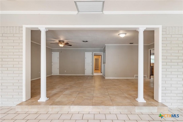 1223 N Sarah Dewitt Dr, Gonzales, TX 78629 - spare room featuring a ceiling fan, ornate columns, light tile patterned floors, crown molding, and baseboards