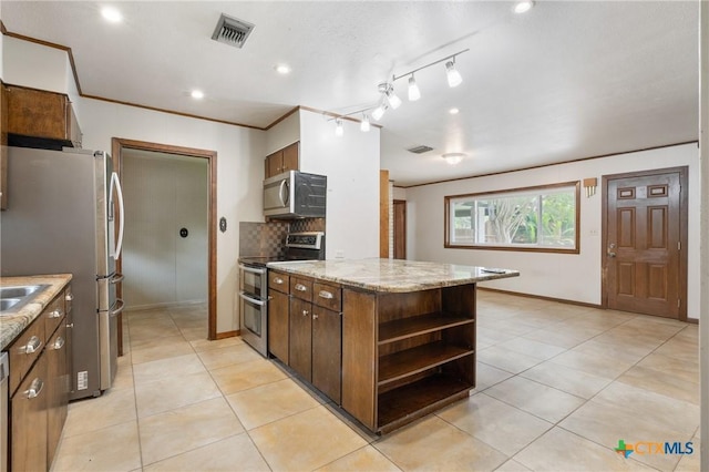 1223 N Sarah Dewitt Dr, Gonzales, TX 78629 - kitchen with stainless steel appliances, open shelves, light tile patterned flooring, tasteful backsplash, and recessed lighting