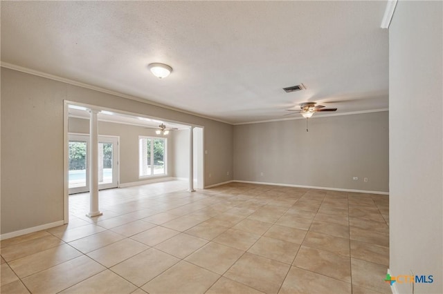 1223 N Sarah Dewitt Dr, Gonzales, TX 78629 - spare room featuring ceiling fan, light tile patterned flooring, ornamental molding, decorative columns, and baseboards