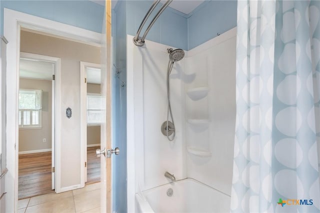 1223 N Sarah Dewitt Dr, Gonzales, TX 78629 - bathroom featuring shower / bathtub combination with curtain, tile patterned flooring, and baseboards