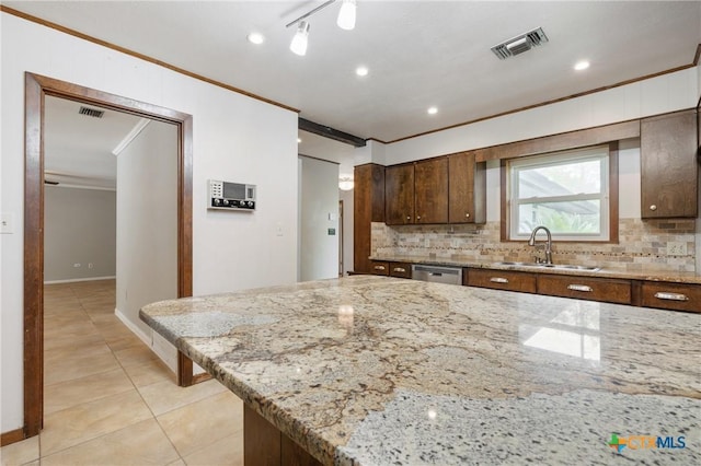 1223 N Sarah Dewitt Dr, Gonzales, TX 78629 - kitchen featuring crown molding, a sink, dishwasher, tasteful backsplash, and light tile patterned floors