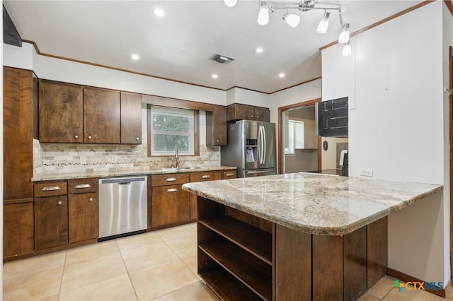 1223 N Sarah Dewitt Dr, Gonzales, TX 78629 - kitchen featuring stainless steel appliances, ornamental molding, open shelves, a peninsula, and tasteful backsplash