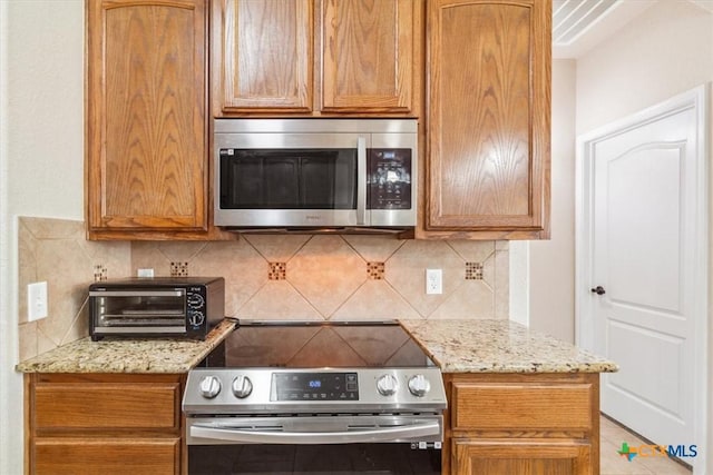 800 Hailie, Killeen, TX 76542 - kitchen with light stone countertops, stainless steel appliances, and decorative backsplash