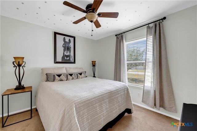 bedroom with light colored carpet and ceiling fan