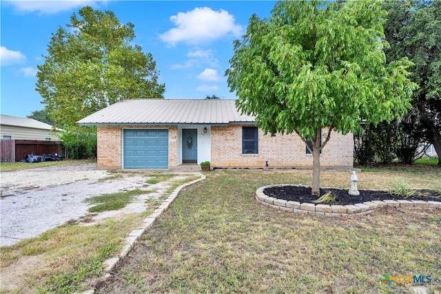 ranch-style home featuring a front lawn and a garage