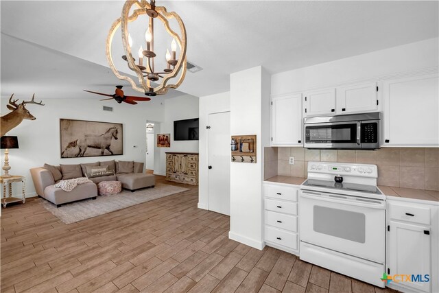 kitchen with tasteful backsplash, light wood-type flooring, white electric stove, hanging light fixtures, and white cabinets