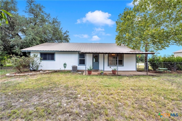 ranch-style home with central AC and a front lawn