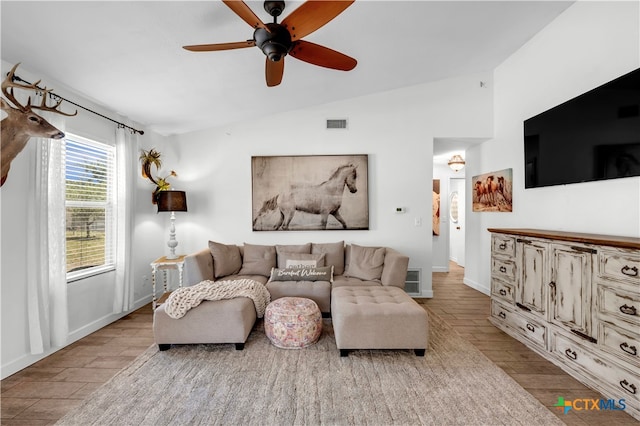 living room featuring light wood-type flooring, ceiling fan, and vaulted ceiling