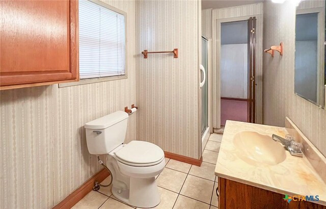 1412 N Beal St, Belton, TX 76513 - full bathroom with wallpapered walls, vanity, tile patterned floors, toilet, and a stall shower