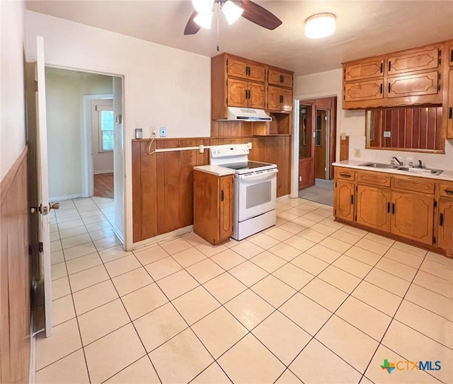 kitchen featuring white range with electric cooktop, under cabinet range hood, a sink, light countertops, and ceiling fan