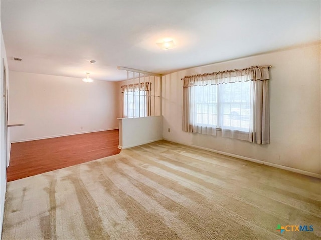 1412 N Beal St, Belton, TX 76513 - carpeted spare room featuring baseboards and a chandelier