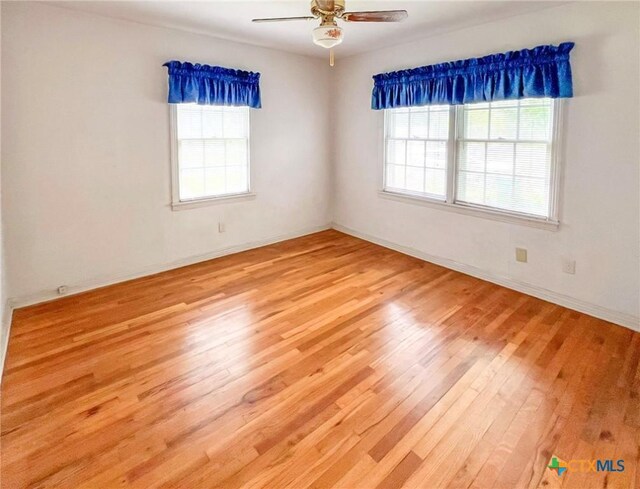 1412 N Beal St, Belton, TX 76513 - spare room featuring wood finished floors, ceiling fan, and baseboards