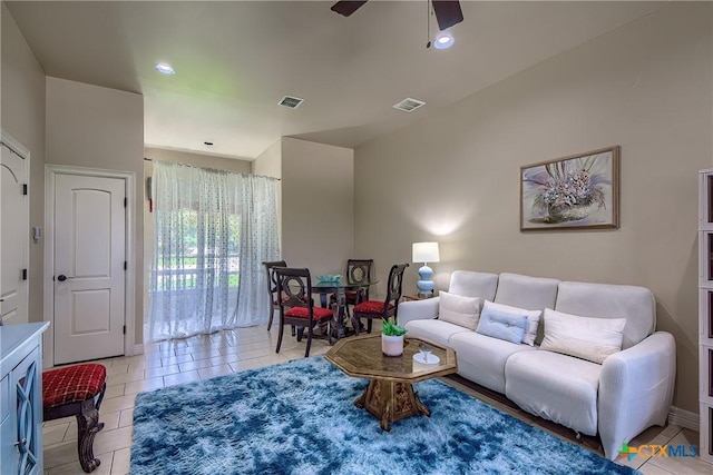 living room featuring light tile patterned floors, recessed lighting, visible vents, and a ceiling fan