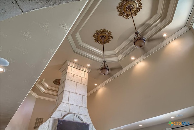 interior details with ornamental molding, a raised ceiling, and recessed lighting