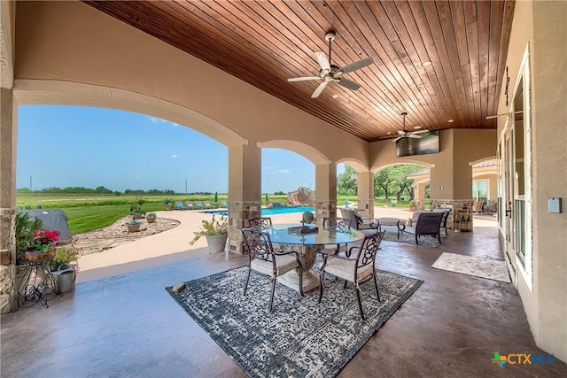 view of patio featuring outdoor dining area and ceiling fan