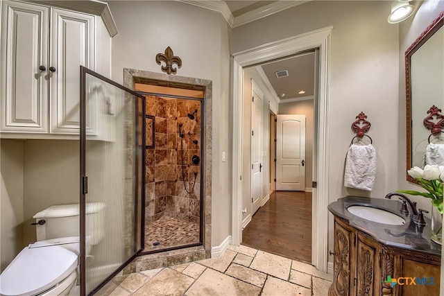 full bathroom featuring ornamental molding, a stall shower, vanity, and stone tile flooring