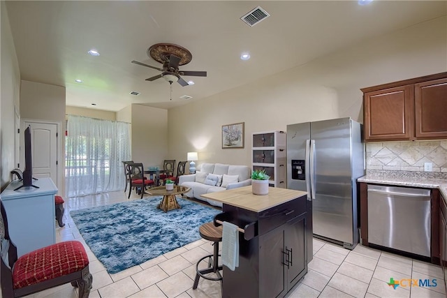 kitchen featuring light tile patterned floors, tasteful backsplash, visible vents, stainless steel appliances, and light countertops