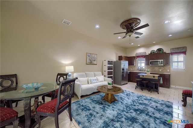 living area featuring recessed lighting, light tile patterned flooring, visible vents, and a ceiling fan