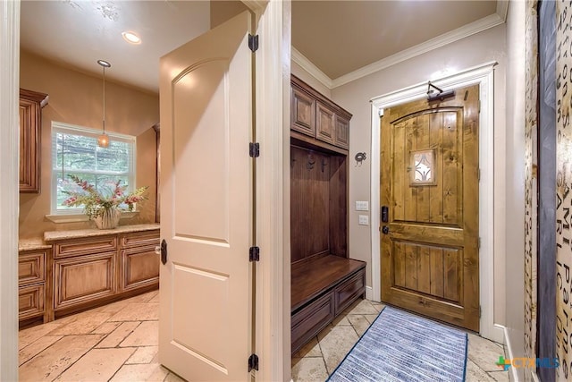 mudroom featuring stone tile flooring and crown molding