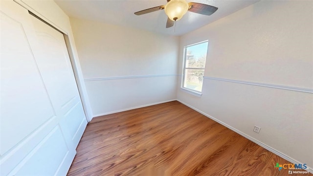 unfurnished bedroom featuring a closet, ceiling fan, and hardwood / wood-style flooring