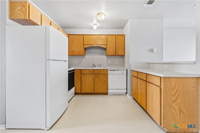 kitchen with light countertops, white appliances, light floors, and visible vents