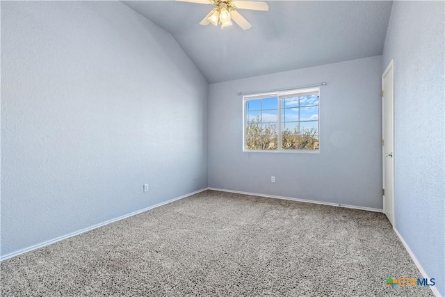 spare room featuring lofted ceiling, baseboards, a ceiling fan, and carpet flooring