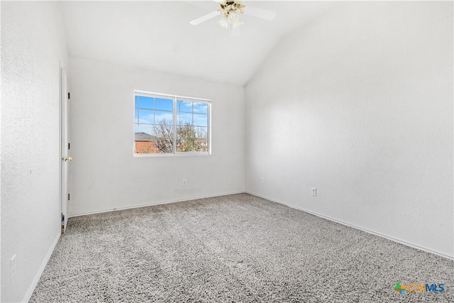 empty room featuring lofted ceiling, ceiling fan, and baseboards