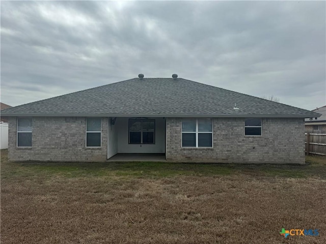 rear view of property with a lawn