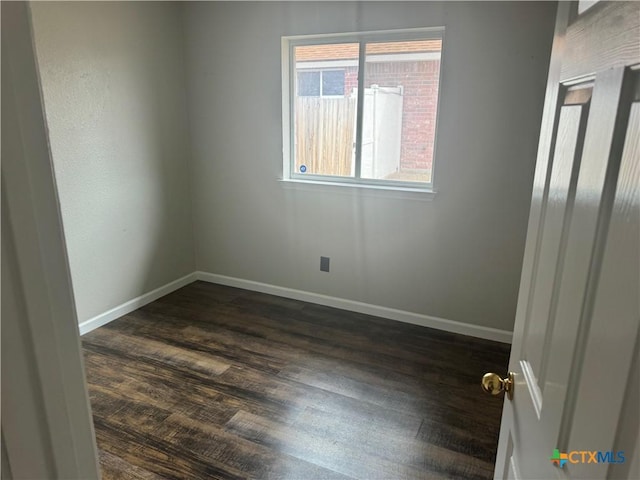 unfurnished room featuring dark hardwood / wood-style flooring