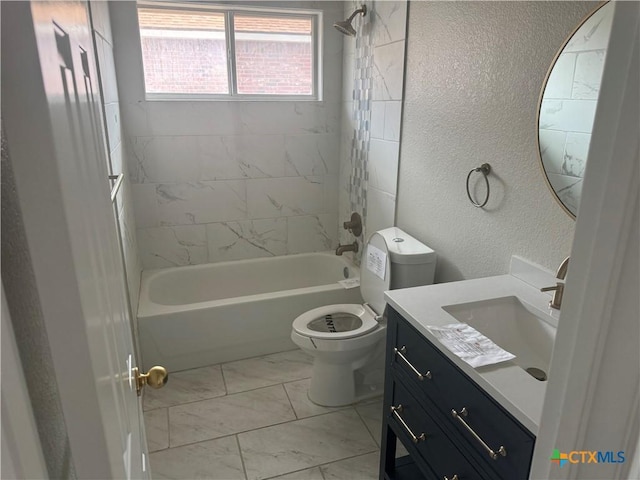 full bathroom featuring tiled shower / bath, vanity, and toilet