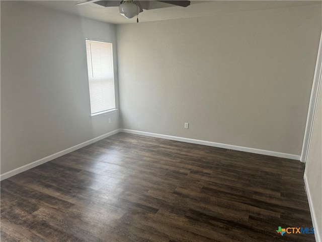 unfurnished room with dark wood-type flooring and ceiling fan