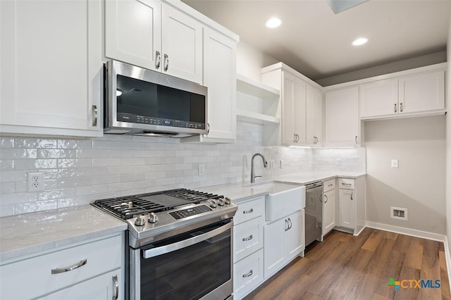 200 County Road 246, Florence, TX 76527 - kitchen featuring stainless steel appliances, a sink, open shelves, light stone countertops, and white cabinets