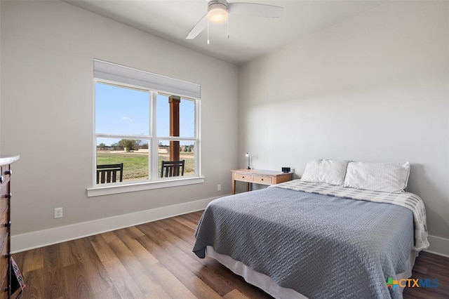 200 County Road 246, Florence, TX 76527 - bedroom with baseboards, wood finished floors, and ceiling fan