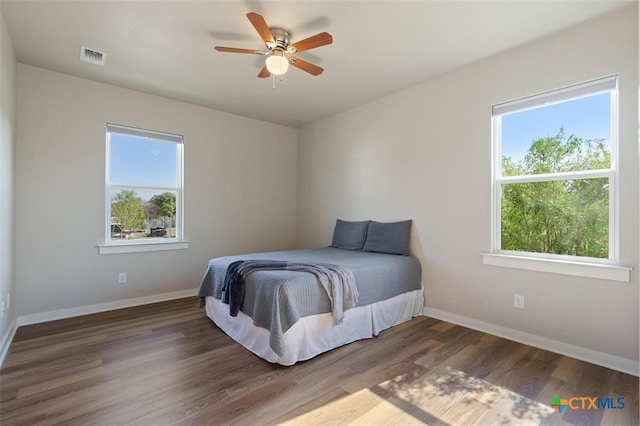 200 County Road 246, Florence, TX 76527 - bedroom featuring multiple windows, baseboards, and wood finished floors