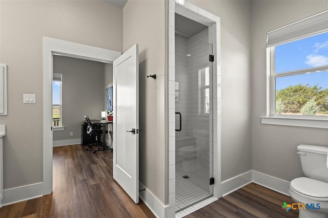 200 County Road 246, Florence, TX 76527 - full bathroom with toilet, a stall shower, wood finished floors, and baseboards