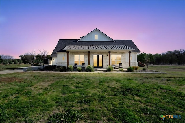 200 County Road 246, Florence, TX 76527 - modern farmhouse with a lawn, a standing seam roof, a porch, and stone siding